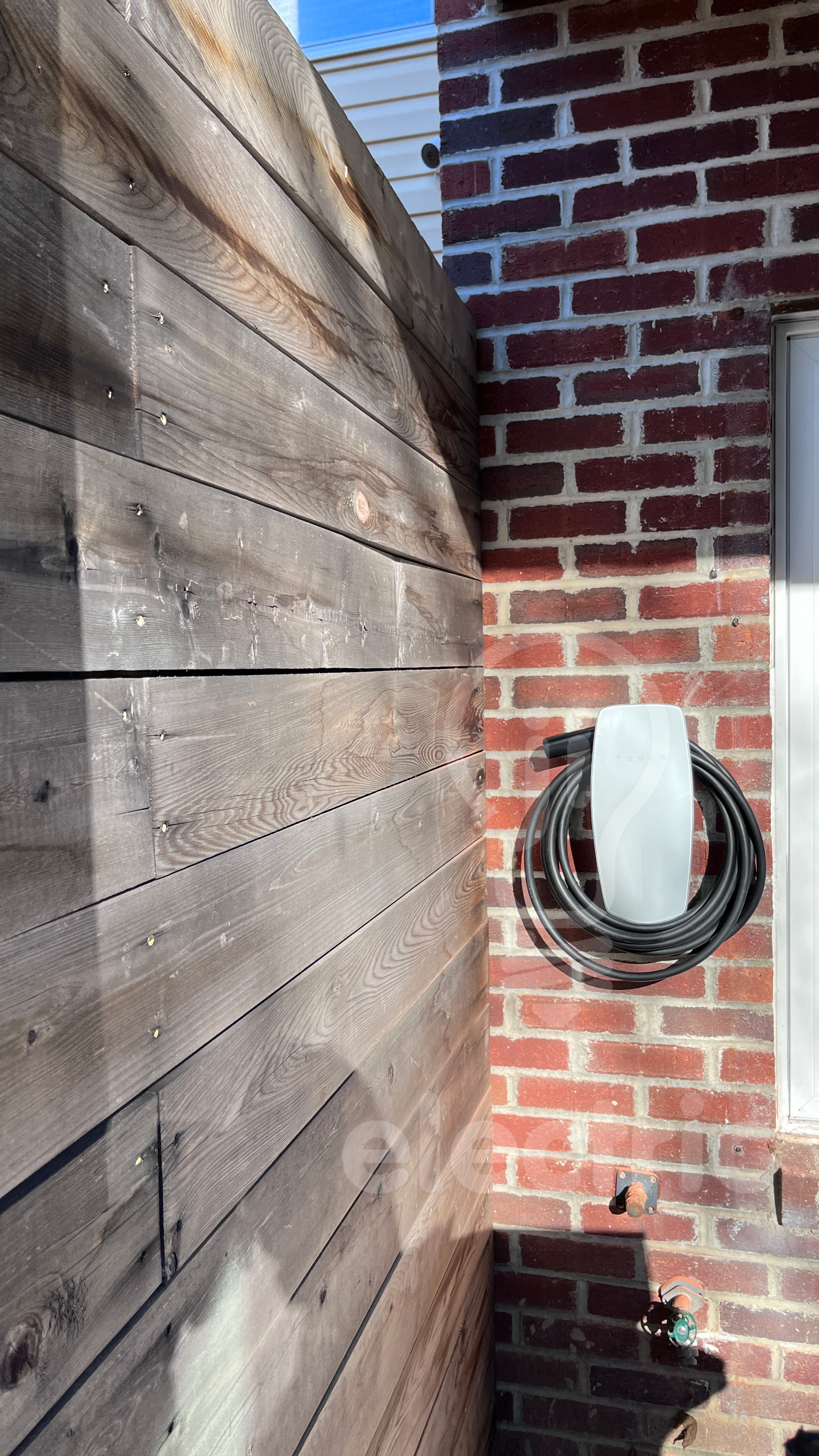 Tesla wall connector installed outside concealed finished.